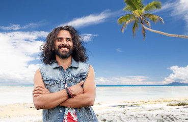 Image showing smiling hippie man in denim vest on summer beach