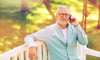 Image showing senior man calling on smartphone at summer park