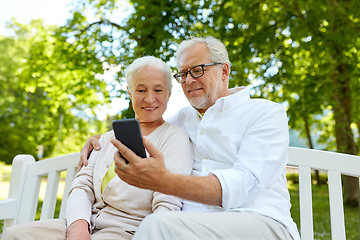 Image showing senior couple with smartphone taking selfie 