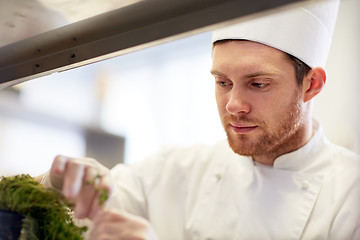 Image showing happy male chef cooking at restaurant kitchen