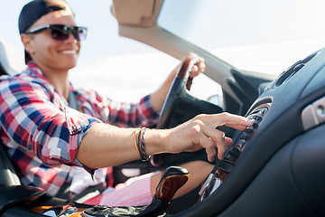 Image showing happy young man driving convertible car