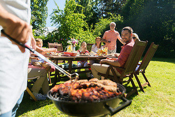 Image showing man cooking meat on barbecue grill at summer party