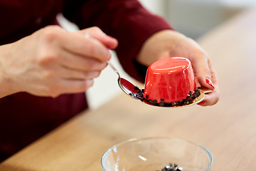 Image showing chef decorating mirror glaze cakes at pastry shop