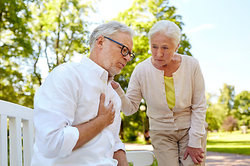 Image showing senior man feeling sick at summer park