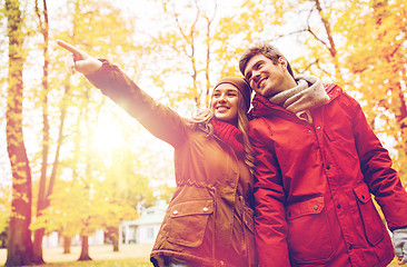 Image showing happy young couple walking in autumn park