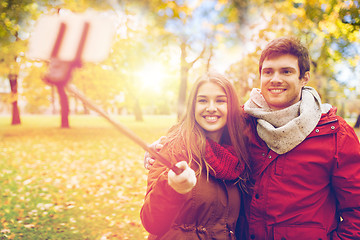 Image showing couple taking selfie by smartphone in autumn park