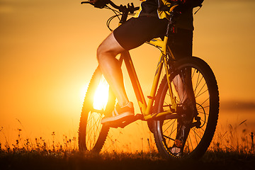 Image showing Man in helmet and glasses stay on the bicycle