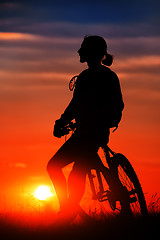 Image showing Silhouette of a bike on sky background