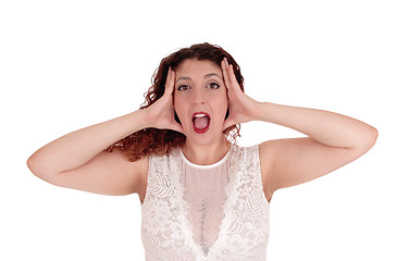 Image showing Woman shouting, hands on head.