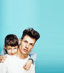 Image showing young pretty man model with little cute son playing together, lifestyle modern people concept, family male 