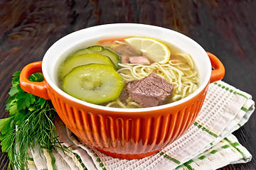 Image showing Soup with zucchini and noodles in red bowl on table