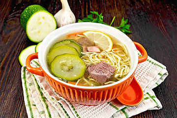 Image showing Soup with zucchini and noodles in bowl on board