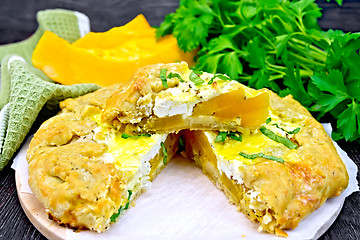 Image showing Pie of pumpkin and cheese on dark board