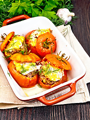 Image showing Tomatoes stuffed with rice and meat in brazier on dark board