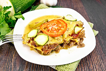 Image showing Casserole from minced meat and zucchini in plate on board
