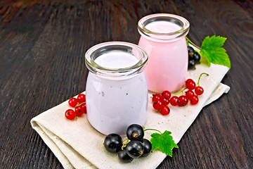 Image showing Milk cocktail with black and red currant on dark board