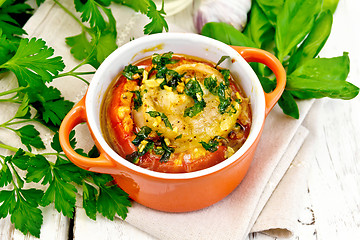 Image showing Fish baked with tomato in red pot on towel