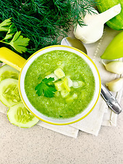 Image showing Soup cucumber in yellow bowl on stone table top