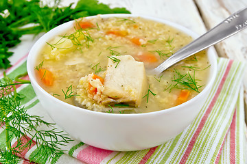 Image showing Soup fish with millet and spoon on board