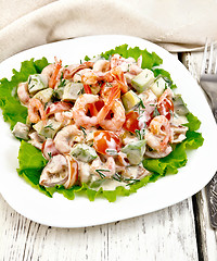 Image showing Salad with shrimp and tomato in white plate on light board