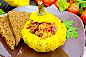 Image showing Squash yellow stuffed with meat on dark board