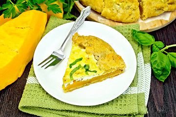 Image showing Pie of pumpkin and cheese in plate on napkin