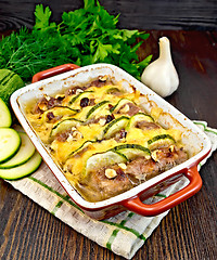 Image showing Meatballs with zucchini and nuts in brazier on dark board