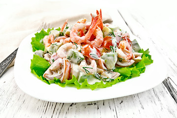 Image showing Salad with shrimp and avocado in plate on light board