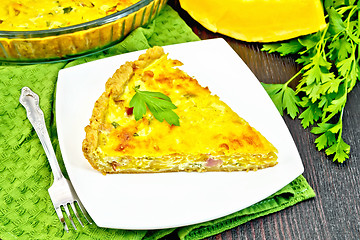 Image showing Quiche with pumpkin and bacon in plate on dark board