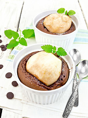 Image showing Cake chocolate with pear and mint in white bowl on board