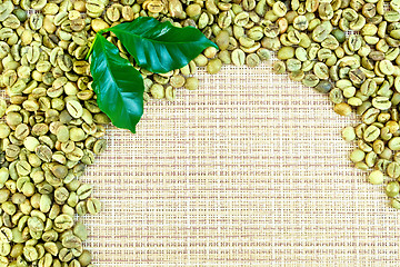 Image showing Coffee green grains on yellow woven fabric