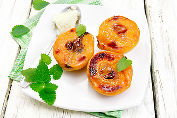 Image showing Quince baked with ice-cream and mint in plate on board