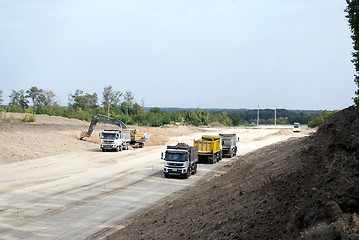 Image showing road construction dump trucks excavator