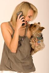 Image showing Fashionable woman with cell phone and dog