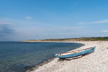 Image showing Blue rowing boat by seaside