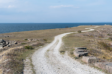 Image showing Winding gravel road in a coastal landscape