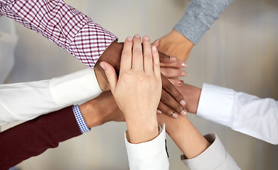 Image showing business team with hands on top at office