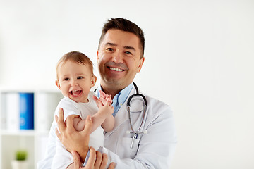 Image showing happy doctor or pediatrician with baby at clinic