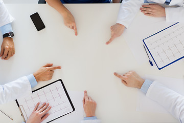 Image showing group of doctors with cardiograms working at table