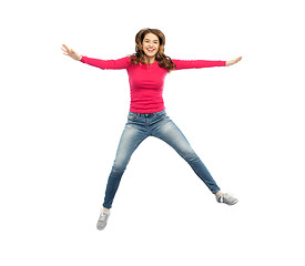 Image showing smiling young woman jumping in air