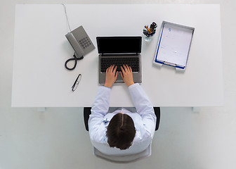 Image showing doctor typing on laptop at clinic