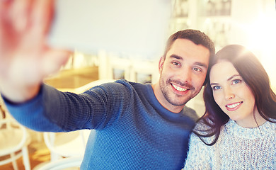 Image showing couple taking smartphone selfie at cafe restaurant