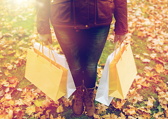 Image showing woman with shopping bags in autumn park