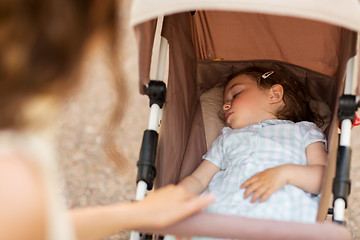 Image showing mother with child sleeping in stroller