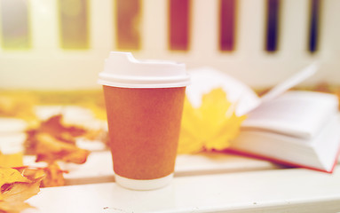 Image showing coffee drink in paper cup on bench at autumn park