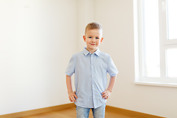 Image showing smiling little boy at empty room of new home