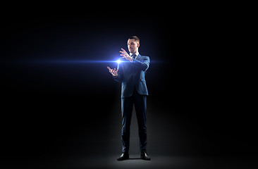 Image showing businessman with laser light over black