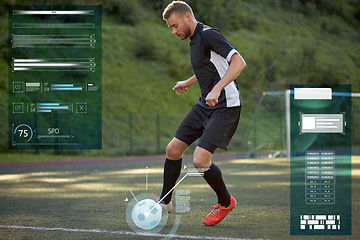 Image showing soccer player playing with ball on football field