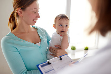 Image showing happy woman with baby and doctor at clinic