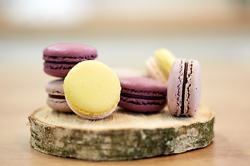 Image showing different macarons on wooden stand